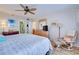 Main bedroom with king bed, dresser, and relaxing armchair at 232 Saint Augustine Ave # 105, Venice, FL 34285