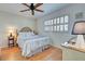 Guest bedroom with a full-size bed and wood flooring at 232 Saint Augustine Ave # 105, Venice, FL 34285