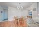 Dining area with light teal table, chairs, and mirrored room divider at 232 Saint Augustine Ave # 105, Venice, FL 34285