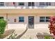 Condo building entry with gray door and windows at 232 Saint Augustine Ave # 105, Venice, FL 34285