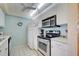 Bright kitchen features white cabinets, stainless steel appliances, and light blue walls at 232 Saint Augustine Ave # 105, Venice, FL 34285
