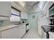 Efficient galley kitchen with white cabinets and appliances at 232 Saint Augustine Ave # 105, Venice, FL 34285