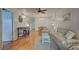 Living room features hardwood floors, light-colored couch, and a small table at 232 Saint Augustine Ave # 105, Venice, FL 34285