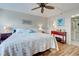 King-size bed, ceiling fan, and hardwood floors in the main bedroom at 232 Saint Augustine Ave # 105, Venice, FL 34285