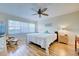 Main bedroom with king-size bed, ceiling fan, and hardwood floors at 232 Saint Augustine Ave # 105, Venice, FL 34285