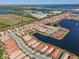Aerial view of a home community with lake and houses at 232 Teramo Way, Nokomis, FL 34275