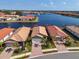 Single-story home with a two-car garage and a lake view at 232 Teramo Way, Nokomis, FL 34275