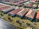 Single-story home with a two-car garage and a lake view at 232 Teramo Way, Nokomis, FL 34275