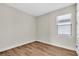 Simple bedroom with hardwood floors and a window with blinds at 232 Teramo Way, Nokomis, FL 34275