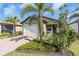 Single story house with a two-car garage and palm trees at 232 Teramo Way, Nokomis, FL 34275