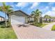 Two-story house with a two-car garage, landscaping and a brick driveway at 232 Teramo Way, Nokomis, FL 34275