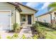 Front entry with walkway, landscaping, and a dark door at 232 Teramo Way, Nokomis, FL 34275