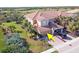 Aerial view of two-story townhome with two-car garage and golf course views at 23619 Awabuki Dr, Venice, FL 34293