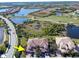 Aerial view showcasing community, lake, golf course, and subject property at 23619 Awabuki Dr, Venice, FL 34293