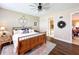 Main bedroom with wooden bed frame and ensuite bathroom at 23619 Awabuki Dr, Venice, FL 34293