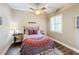 Cozy bedroom with a full bed, window with shutters, and hardwood floors at 23619 Awabuki Dr, Venice, FL 34293