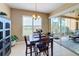 Bright dining area with table and chairs, view to screened patio at 23619 Awabuki Dr, Venice, FL 34293