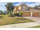 Two-story townhome with double garage and lush landscaping at 23619 Awabuki Dr, Venice, FL 34293