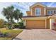 Front view of two-story townhome featuring double garage at 23619 Awabuki Dr, Venice, FL 34293
