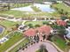 Community clubhouse near golf course with a tile roof at 23619 Awabuki Dr, Venice, FL 34293