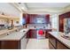 Kitchen with dark wood cabinets, granite countertops and island at 23619 Awabuki Dr, Venice, FL 34293
