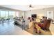 Spacious living room with tiled floors and access to a patio at 23619 Awabuki Dr, Venice, FL 34293