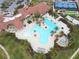 Community pool with surrounding lounge chairs and landscaping at 23619 Awabuki Dr, Venice, FL 34293
