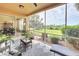 Relaxing screened patio overlooking a grassy backyard at 23619 Awabuki Dr, Venice, FL 34293