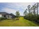 Home with spacious backyard, screened patio, and lush landscaping at 2751 Lavandula Ct, North Port, FL 34289