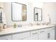 Elegant bathroom with double vanity and modern black framed mirrors at 2751 Lavandula Ct, North Port, FL 34289
