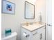 Small bathroom with white vanity, a modern mirror, and a toilet at 2751 Lavandula Ct, North Port, FL 34289