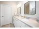 Double vanity bathroom with white cabinets and quartz countertops at 2751 Lavandula Ct, North Port, FL 34289