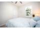 Bedroom with a bed, ceiling fan, window with shutters, and a door at 2751 Lavandula Ct, North Port, FL 34289