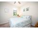 Guest bedroom with a light teal comforter, ceiling fan, and a guitar at 2751 Lavandula Ct, North Port, FL 34289