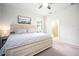 Main bedroom with king bed, en-suite bathroom, and ceiling fan at 2751 Lavandula Ct, North Port, FL 34289