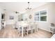 Dining area with white table, chairs, and a chandelier at 2751 Lavandula Ct, North Port, FL 34289