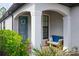 Front porch with blue bench, wreath and brick flooring at 2751 Lavandula Ct, North Port, FL 34289
