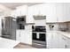 Bright kitchen featuring stainless steel appliances and white shaker cabinets at 2751 Lavandula Ct, North Port, FL 34289