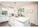 Modern kitchen with white cabinets, quartz countertops, and stainless steel appliances at 2751 Lavandula Ct, North Port, FL 34289