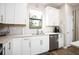 Clean and spacious kitchen with white cabinets and stainless steel dishwasher at 2751 Lavandula Ct, North Port, FL 34289