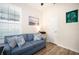 Bright office with blue couch, window with plantation shutters, and built-in shelving at 2751 Lavandula Ct, North Port, FL 34289