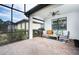 Covered patio with brick flooring, seating area, and screened enclosure at 2751 Lavandula Ct, North Port, FL 34289