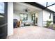 Relaxing covered patio with seating area, ceiling fan, and screened enclosure at 2751 Lavandula Ct, North Port, FL 34289