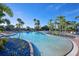 Resort-style pool with palm trees and lounge chairs at 2751 Lavandula Ct, North Port, FL 34289