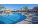 Community pool with a large deck and surrounding landscaping at 2751 Lavandula Ct, North Port, FL 34289