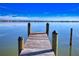 Wooden dock extending over calm water under a sunny sky at 2985 N Beach Rd # C8-1, Englewood, FL 34223