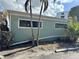 Light green waterfront home with board-up windows at 2985 N Beach Rd # C8-1, Englewood, FL 34223