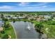 Aerial view of community with lake and lush landscaping at 3348 Lakeview Ln, North Port, FL 34287