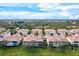 Aerial view of villa community showcasing a lake and lush landscape at 4206 Vicenza Dr # C24, Venice, FL 34293