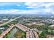 Aerial view showing property location near a road and lake at 4206 Vicenza Dr # C24, Venice, FL 34293